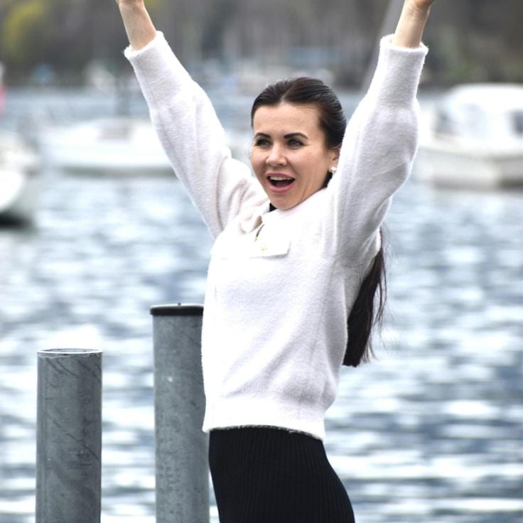 Avery Kim, Lead Design Curator at ParadexiMundo, reviewing corporate floral arrangements